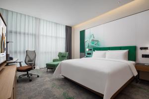 Voodi või voodid majutusasutuse Hampton by Hilton Guangzhou Xintang toas