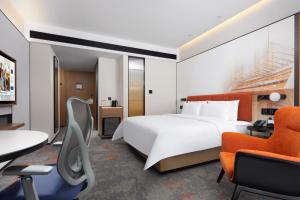 Voodi või voodid majutusasutuse Hampton by Hilton Guangzhou Xintang toas