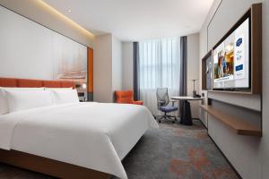 Voodi või voodid majutusasutuse Hampton by Hilton Guangzhou Xintang toas