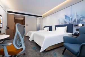 Voodi või voodid majutusasutuse Hampton by Hilton Guangzhou Xintang toas