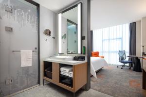 Voodi või voodid majutusasutuse Hampton by Hilton Guangzhou Xintang toas