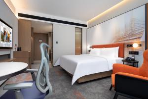 Voodi või voodid majutusasutuse Hampton by Hilton Guangzhou Xintang toas