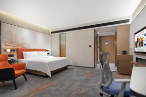 Voodi või voodid majutusasutuse Hampton by Hilton Guangzhou Xintang toas