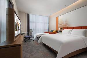 Voodi või voodid majutusasutuse Hampton by Hilton Guangzhou Xintang toas