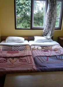 Ένα ή περισσότερα κρεβάτια σε δωμάτιο στο Hotel Pemathang