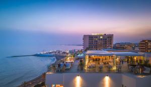 a view of a beach at night with tables and chairs at El Fuerte Marbella in Marbella