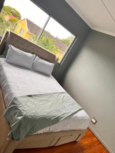 a bed in a room with a large window at Number 87 in East London