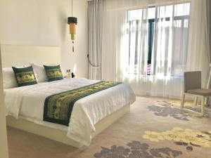 En eller flere senge i et værelse på 慧兰酒店bodhi hotel
