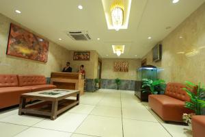 a lobby with couches and a table in a building at HOTEL SVM GRAND RAMANTHAPUR in Hyderabad