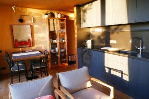 a kitchen with a sink and a table with chairs at Gite des Bois de Spa in Spa