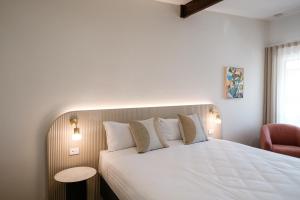מיטה או מיטות בחדר ב-The Timothée Resort