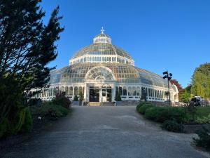 a large glass greenhouse in a garden at 2025 Award Winner Liverpool Peach House - 4 Bedrooms in Liverpool