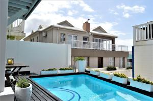 a swimming pool in the backyard of a house at Point Village Guest House in Mossel Bay