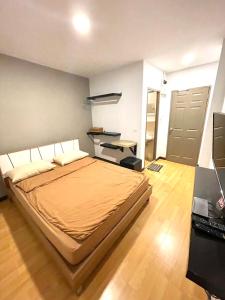 een slaapkamer met een bed, een bureau en een deur bij Inn Trog And Inn Soi in Bangkok