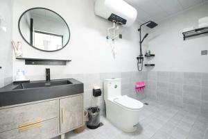 a bathroom with a toilet and a sink and a mirror at Creek Tang B&B in Huairou
