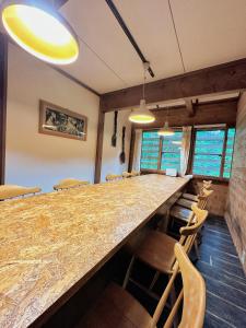 a conference room with a long counter and chairs at Moment Chalet Hakuba in Hakuba
