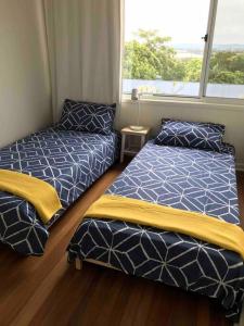 Ένα ή περισσότερα κρεβάτια σε δωμάτιο στο Shelly Beach Townhouse