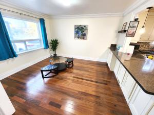 a kitchen and living room with wood floors and a table at Toronto Uptown 3 - Bus to Downtown in Toronto +2 photos