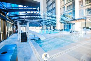 a swimming pool with a slide in a building at Royal Serviced apartment Vinhomes Metropolis in Hanoi