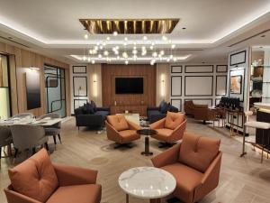 a lobby with chairs and tables and a chandelier at Crowne Plaza - Dubai Jumeirah by IHG in Dubai