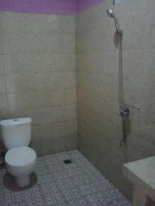 a bathroom with a toilet and a shower at OYO 93241 Hotel Puri Azzura Danau Ranau in Jepara