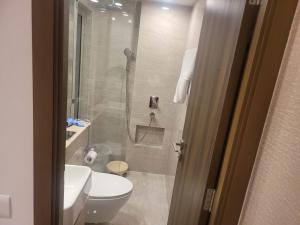 a bathroom with a shower and a toilet and a sink at Sapphire Asta- Regent Hills in Mumbai