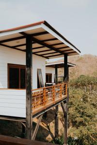 a house with a wooden deck in front of it at Disini Lombok ECO Sky House, Selong Belanak in Selong Belanak