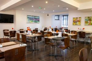 a dining room with tables and chairs at The Grosvenor Plymouth in Plymouth