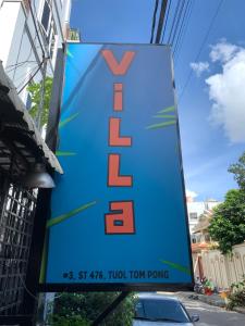 a sign for a v store on a street at Villa Martial Arts Gym & Guesthouse in Phnom Penh