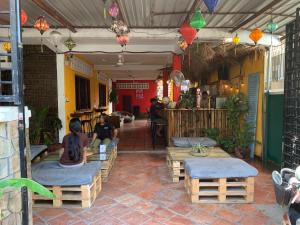 a group of people sitting on benches in a patio at Villa Martial Arts Gym & Guesthouse in Phnom Penh