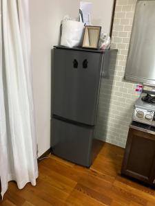 a small refrigerator in a corner of a room at 民泊　筑紫野 in Chikushino