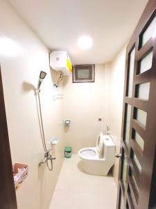 a bathroom with a toilet and a light in it at Kemnpi Homestay in Hue