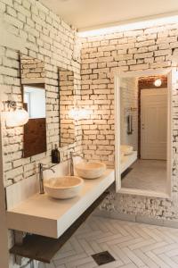 two sinks in a bathroom with a brick wall at Mia Glamping in Orissaare