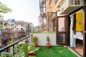 - un balcon avec pelouse et plantes dans un bâtiment dans l'établissement Lime Boutique Bed & Breakfast -Near Eros Hotel Nehru Place Metro, à New Delhi
