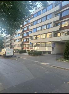 a van parked in front of a large building at Amazing Studio by Royal Palace in Oslo