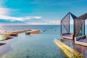 a view of the water from a hotel pool at EDGE Sea View Holiday inn Pattaya Central in Pattaya