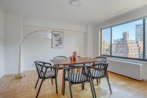 a dining room with a table and chairs and a window at West Village 1br w gym private wd nr ark NYC-1276 in New York