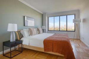 a bedroom with a large bed and a large window at West Village 1br w gym private wd nr ark NYC-1276 in New York