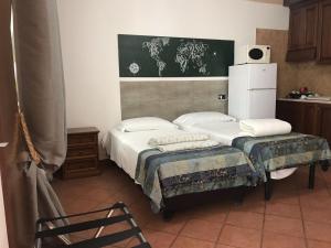 a bedroom with two beds and a chair in it at EURO HOUSE INN airport in Fiumicino