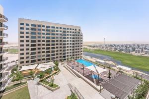 an overhead view of a large building with a pool at StoneTree - Spacious 2BR Apartment in Golf Views Block A in Dubai