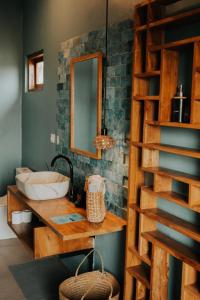 a bathroom with a sink and a mirror at Disini Lombok ECO Sky House, Selong Belanak in Selong Belanak