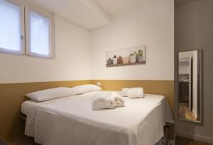 a bedroom with a bed with towels on it at Easylife - Tranquillo studio vicino Prada in Milan