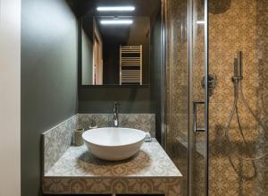 a bathroom with a large bowl sink on a counter at Easylife - Tranquillo studio vicino Prada in Milan +15 photos