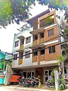 a building with motorcycles parked in front of it at Sunny Day Residences Cainta in Cainta