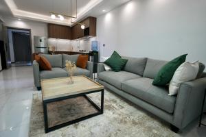 a living room with two couches and a coffee table at An Oasis in the heart of Kigali in Kigali