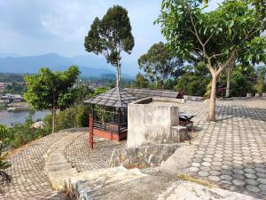 a gazebo on the side of a hill with trees at Arafah Resort @ Danau Kerinci Jambi RedPartner in Hiang