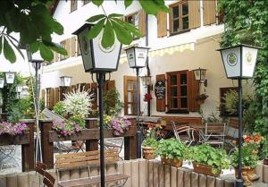 a street light with potted plants in front of a building at Hotel Ristorante Da Franco in Seefeld