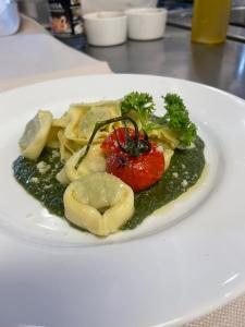 a plate of food with pasta and vegetables on a table at Hotel Ristorante Da Franco in Seefeld