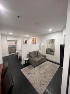 a living room with a couch and a bed at Flinders Lane Apartments in Melbourne