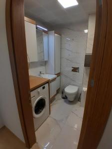 La salle de bains est pourvue d'un lavabo et d'un lave-linge. dans l'établissement Del Puerto Hotel, à Aliağa